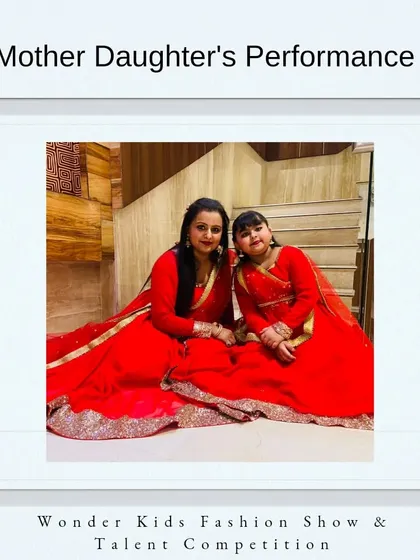 Another wonderful mother-daughter team, Misty and Amyra Anand, ready to grace the stage in matching red traditional outfits. These are the moments that families cherish forever.