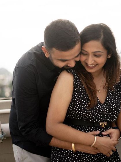 Another angle from this joyful pregnancy announcement, capturing the couple's happy interaction. These candid moments often become the most cherished photos from a session.