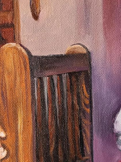 A close-up of the wooden cot and other elements in the background.