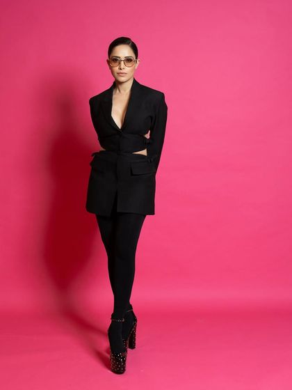 A full-length shot for ELLE, showcasing the unique silhouette of the Valentino outfit and the statement platform heels.