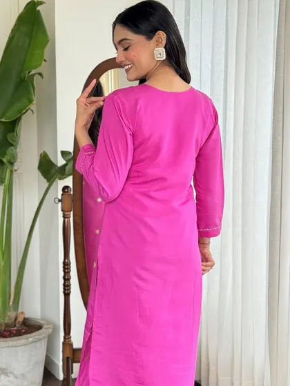 This rani pink kurta pant set is a festive dream. The heavy thread embroidery and sequin work make it a glamorous choice for any celebration.