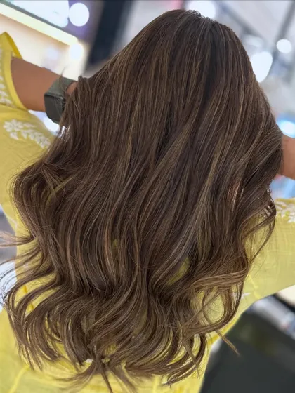 A beautiful beige on mocha highlight blend, perfect for a special occasion. The face-framing layers add an elegant touch to the style.