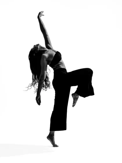 A dynamic black and white shot from 'A Movement Series'. This high-contrast photography captures the power and energy of a single moment of dance.