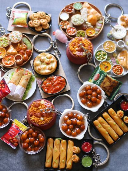 A collection of my most popular keychains, including spring rolls, gulab jamun, and vada pav.