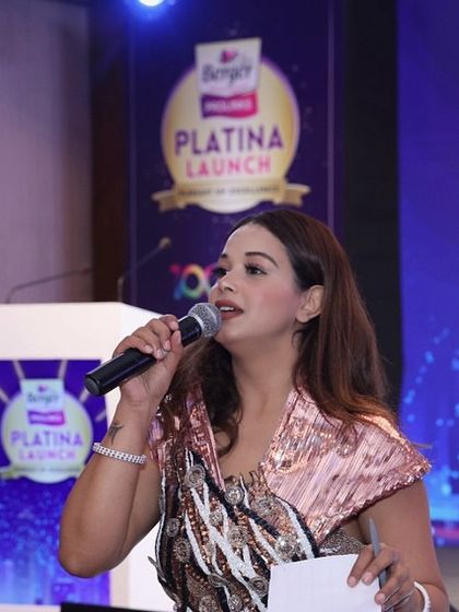 Addressing the attendees at the Berger Paints launch event, ensuring the brand's message is delivered with clarity and energy.