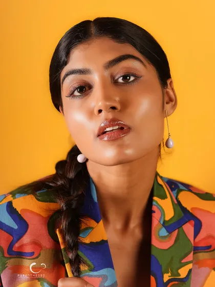A slightly softer expression in this close-up, showing a different side of her personality while still rocking the bold, artistic suit.