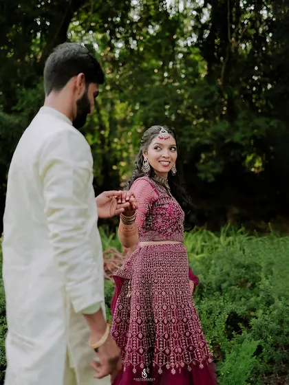 A beautiful "follow me" shot, capturing her joyful expression as she leads him through the woods.