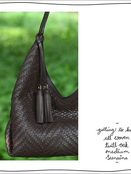 A detail shot of the All Woven Twill Oak Medium Sunaina, highlighting the signature tassels and the intricate texture of the hand-woven leather.