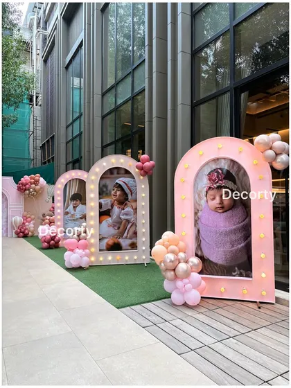 Illuminated photo frames line the walkway, creating a personal and touching gallery of the birthday girl's first year.