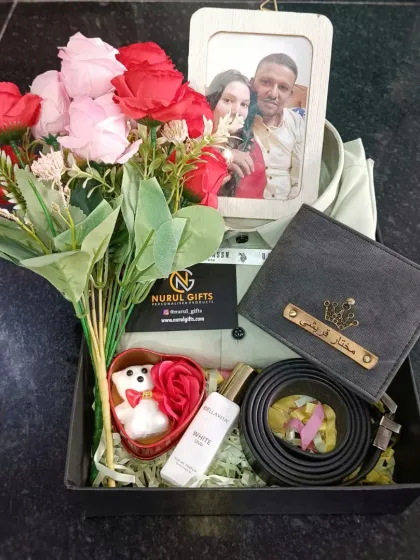 A truly personal and romantic gift. This anniversary hamper includes a shirt, a personalized wallet and belt, perfume, flowers, and a custom photo frame to capture a special memory.