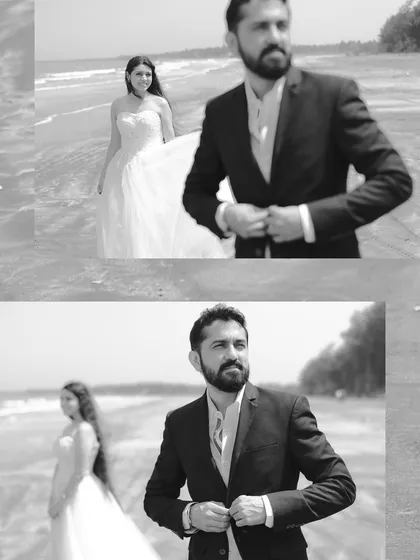 A classic black and white portrait from a beach pre-wedding shoot. The groom is in focus, looking sharp, while his bride is in the background, creating a sense of depth and story.
