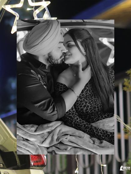 A close-up black and white shot of the couple in a car trunk, focusing on their intimate connection and the romantic ambiance.