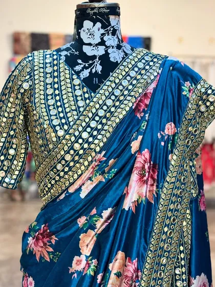 The blouse of the 'NIKHAAR' saree is a statement piece in itself, covered in intricate mirror work that catches the light beautifully.
