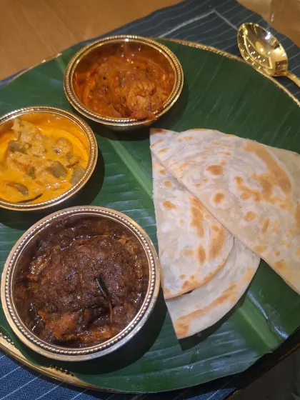 A traditional South Indian meal served in beautiful brass bowls on a banana leaf. The presentation was as authentic as the flavors.