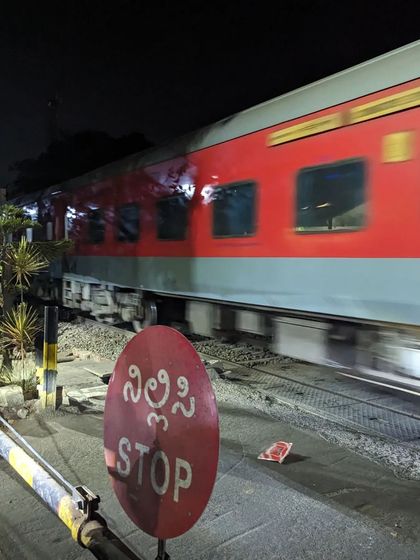Waiting at a railway crossing as a train rushes past in the night. These are the small, unexpected moments of city life that we get to witness on our rides.