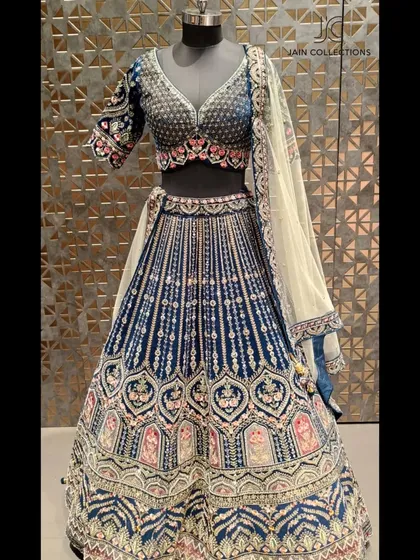 Another view of the royal blue velvet lehenga, showcasing its rich texture and intricate design. A stunning option for the bride who wants a bold and unique color.