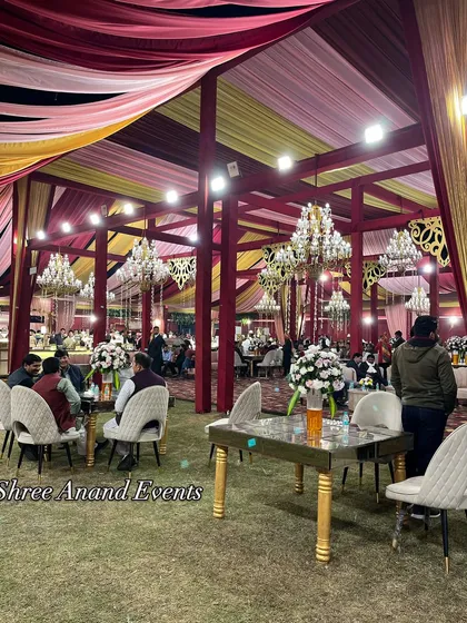 Guests seated at elegantly arranged tables in a large, open-sided marquee, demonstrating our ability to cater to large gatherings.