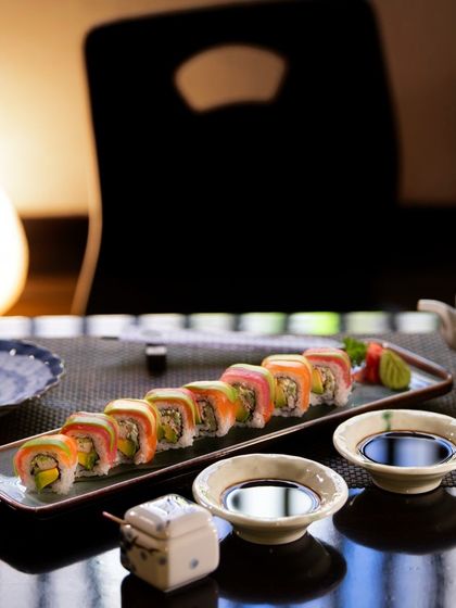 Our Rainbow Sushi Roll, beautifully arranged and ready to be enjoyed. The spectrum of colors from the fresh fish and avocado makes this dish a true feast for the senses.