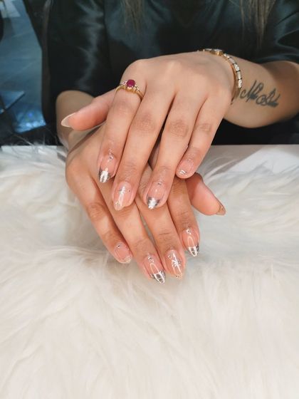 A beautifully composed shot of the silver starburst nails against a soft white background.