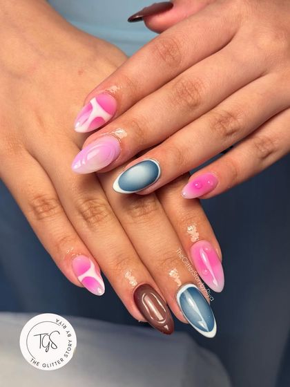 A playful and abstract set combining different colors and techniques. It features a mix of pink aura nails, solid brown, and a cool blue 3D-rimmed accent nail.