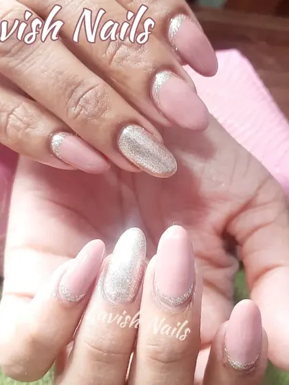 A simple yet chic set with nude pink nails, a full silver glitter accent nail, and subtle glitter French tips.