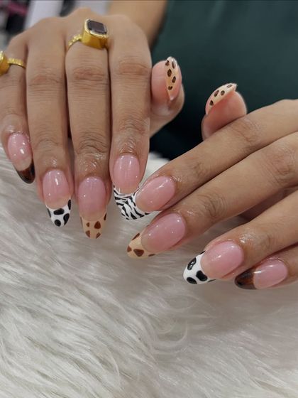Another angle of the popular mixed animal print French tips. This view shows how the different patterns on each nail create a fun and dynamic look.