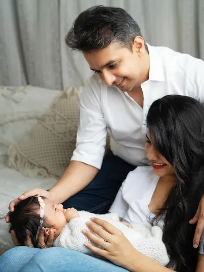 A beautiful family moment, with both parents gazing lovingly at their new baby. These lifestyle shots feel natural and full of emotion.