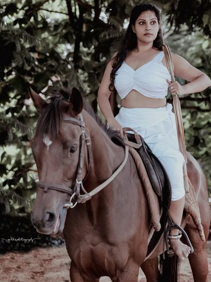 A female warrior concept shoot. These images showcase dynamic action poses, including mid-air shots with a bow and arrow, and serene moments with a horse, all set against a dramatic, smoky backdrop.
