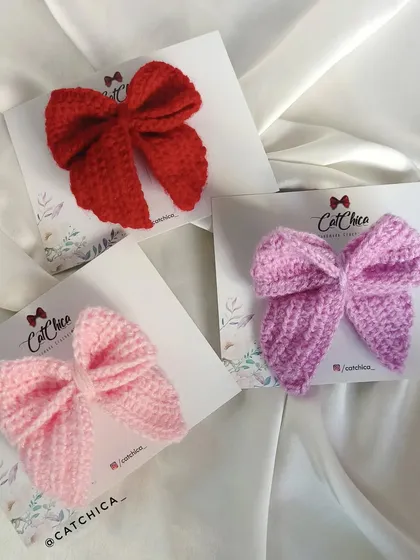 Elevate your style with these charming crochet sailor bows, available in Scarlet Red, Baby Pink, and Lavender Purple.