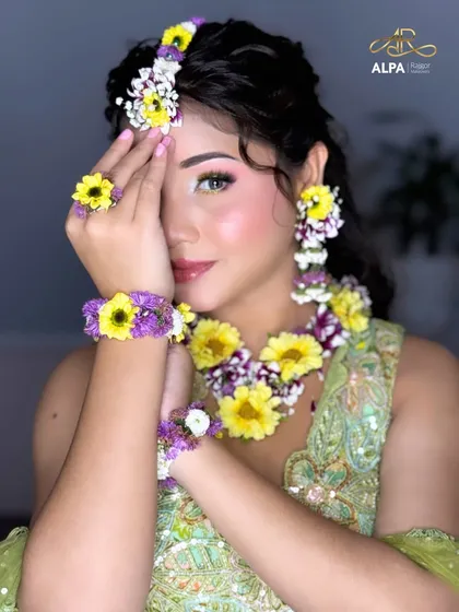 A playful pose that shows off the entire look, from the floral maang tikka to the matching earrings.