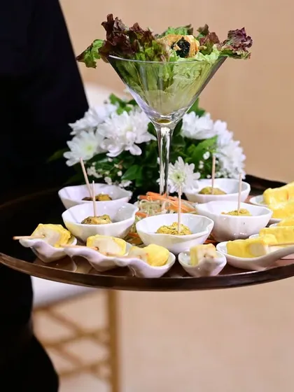 A tray of assorted passed appetizers, including salad martinis and paneer skewers. Our servers ensure that every guest gets to sample these delightful bites.