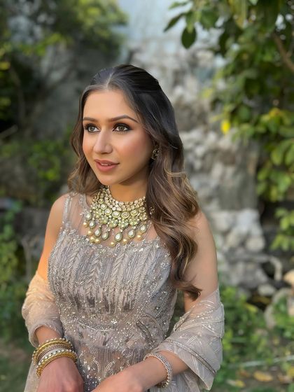 A warm, radiant glam look that highlights the client's natural beauty, perfect for a golden hour event.