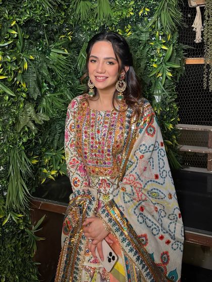 The full look, showing how her colorful outfit is perfectly balanced with fresh, glowing makeup that lets her personality shine.