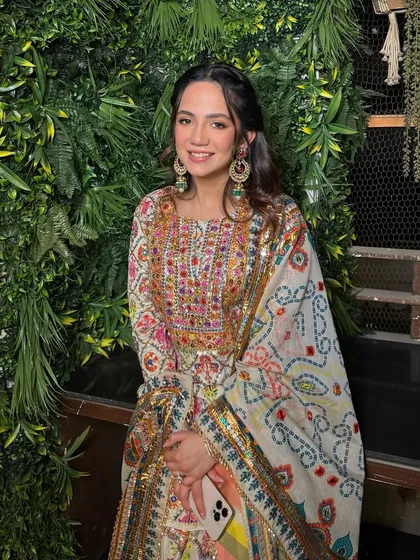 The full look, showing how her colorful outfit is perfectly balanced with fresh, glowing makeup that lets her personality shine.