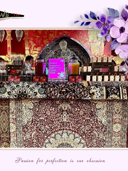 An opulent bar setup with a rich, patterned tablecloth and traditional Indian decor elements, perfectly suited for a grand wedding celebration at Leela Delhi.