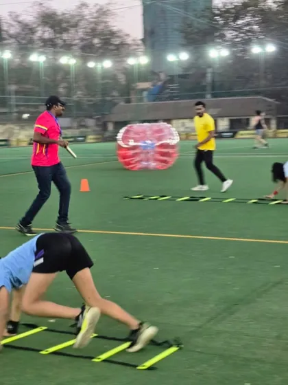 A full view of our turf setup in action. You can see kids engaged in various activities, from ladder drills to Zorb ball fun, all under the watchful eye of our coaches.