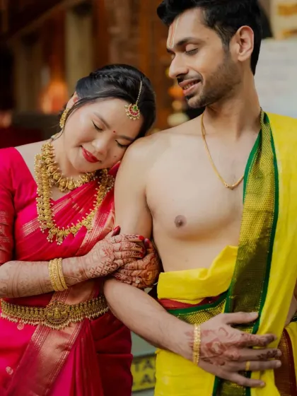 A moment of quiet connection during Anirudh and Lisa's vibrant South Indian temple wedding. The bride rests her head on her new husband's shoulder, a picture of trust and love.