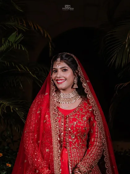 A classic bridal portrait showcasing the intricate details of the wedding lehenga and jewelry. We ensure every bride feels and looks her absolute best in timeless, elegant photographs.