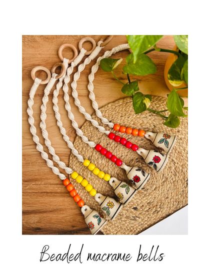 A flat lay of our beaded macrame bells, showcasing the different color combinations available. These little handmade creations are perfect for adding a pop of color and a touch of charm to your home.