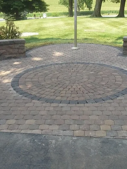 Here you can see a closer look at a paver patio with a built-in seating wall. These low walls are great because they define the space and provide permanent, sturdy seating without cluttering the patio with furniture.
