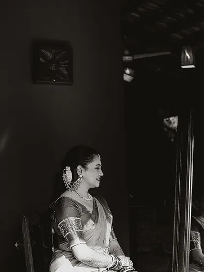 A bride, seen in reflection, a quiet and artistic shot that captures a moment of introspection.