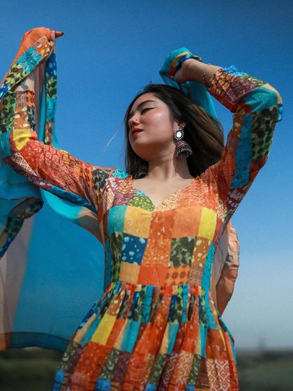 A close-up of the model with her dupatta in the air, capturing a moment of pure freedom and happiness.