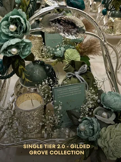 The Single Tier 2.0 from the Gilded Grove Collection. This piece, with its intricate metalwork and natural stone details, is a testament to our commitment to creating unique and memorable wedding gifts.