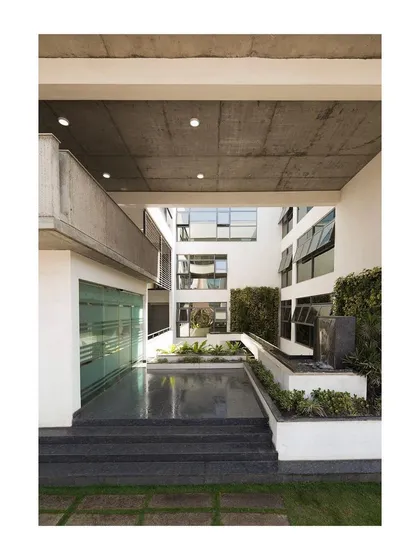 For this corporate office, I designed a multi-level landscaped courtyard at the entrance. A central water channel and waterfall act as a visual connection between levels and also function as a natural humidifier, helping to reduce the building's reliance on air conditioning.