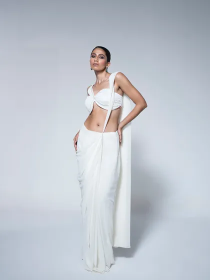 A minimalist and contemporary look from the House of R Spring/Summer collection. This styling of a modern draped saree showcases a clean, elegant aesthetic, focusing on the garment's unique silhouette and subtle craftsmanship.