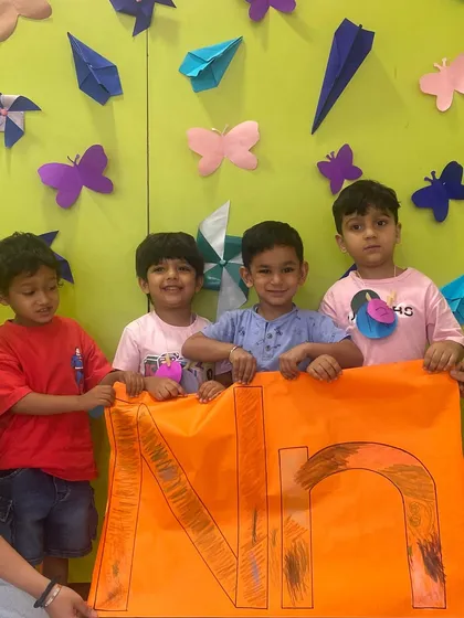 Teamwork makes the dream work! Our Mighty Minds students proudly present the letter 'N' they worked on together. These collaborative projects in our after-school program help build social skills and friendships.