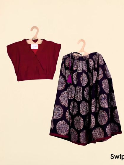 A classic combination of a deep maroon crop top with a beautiful Kalamkari print ghagra. The earthy tones and traditional block print make this a timeless ethnic outfit for girls.