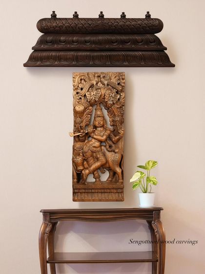 A wall display featuring a carved wooden bracket and a panel depicting Lord Krishna, showcasing how our different pieces can be curated together.