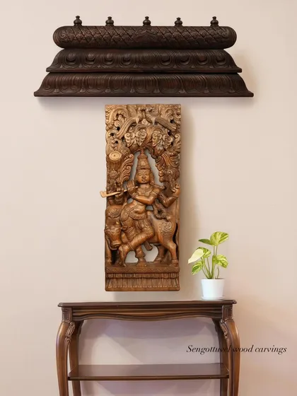 This wall arrangement features a hand-carved panel of Lord Krishna, elegantly mounted above a console table. It demonstrates how our panels can be integrated into home decor to create a serene and traditional focal point.