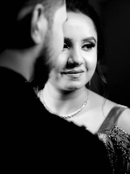 A beautiful black and white portrait of the bride-to-be, with the groom in the foreground, creating a sense of depth and intimacy.